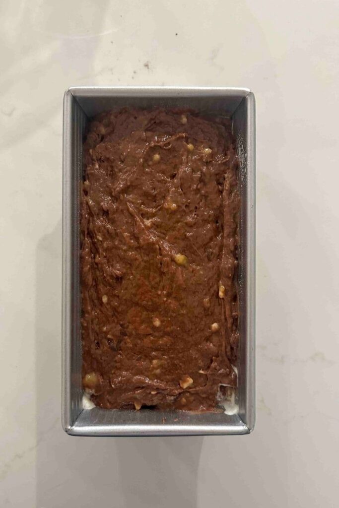 double chocolate sourdough banana bread batter in loaf pan before baking.
