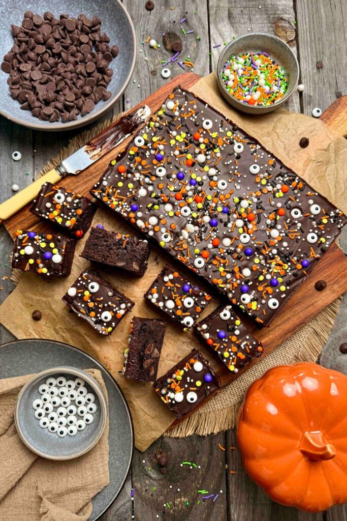 Sourdough Halloween frosted brownies decorated and sliced on cutting board, ready to be served.