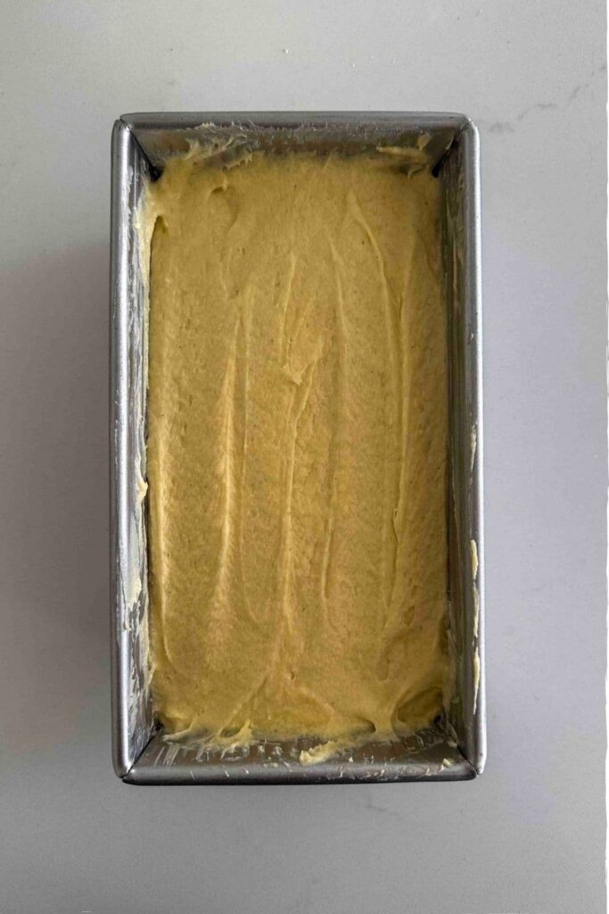 sourdough pound cake batter in a loaf pan.