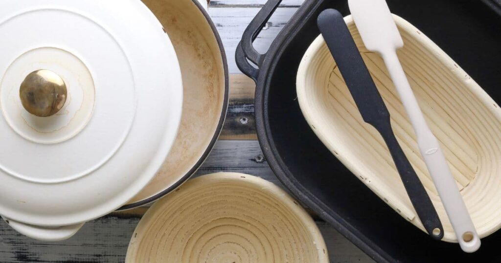 An overhead photo of Dutch Ovens and bannetons ready to make sourdough bread.