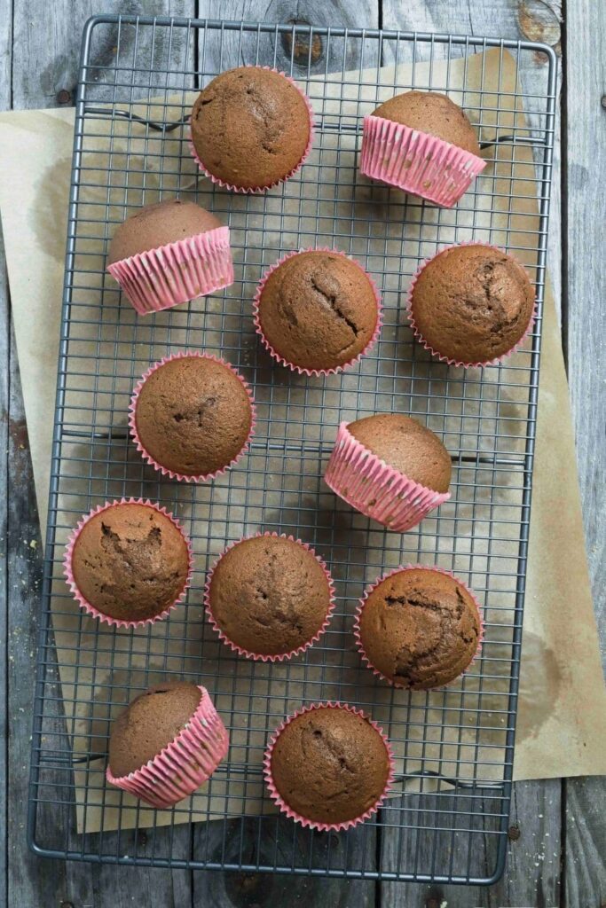 Unfrosted sourdough chocolate cupcakes on wire cooling rack.