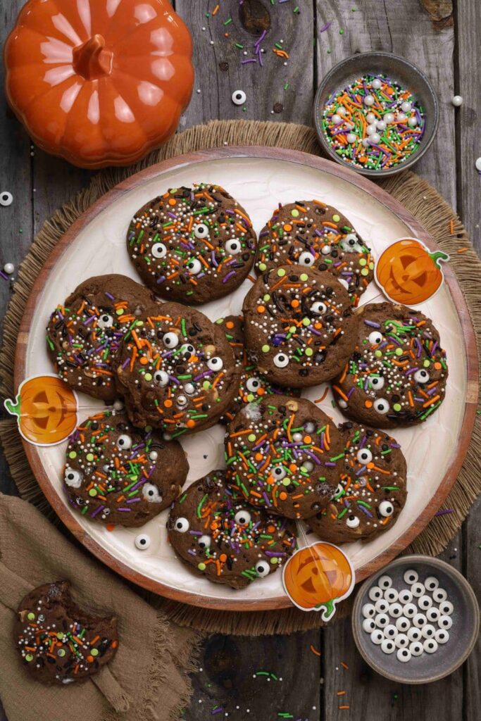 Sourdough Halloween cookies on a plate on a wooden table with Halloween stickers for decoration. 