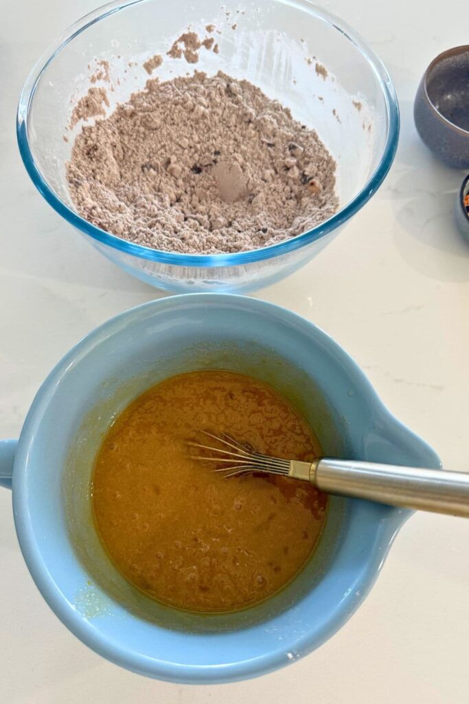 Wet ingredients in a bowl to make sourdough Halloween cookies.