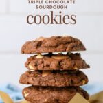 A stack of 5 rich sourdough triple chocolate cookies layered with 3 types of chocolate (semi sweet chocolate, milk chocolate and white chocolate).