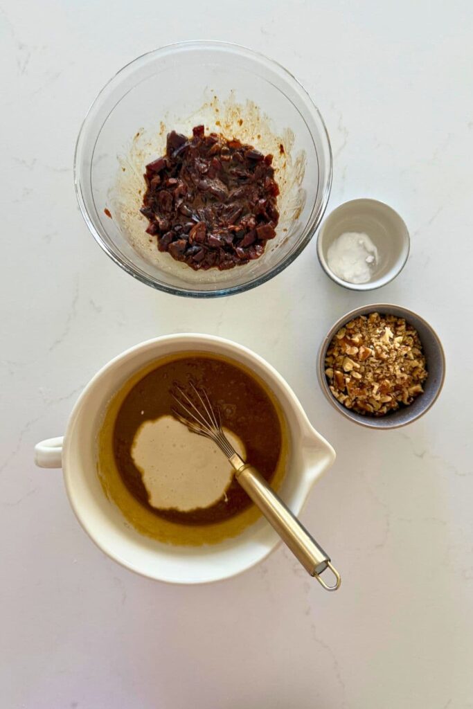 Mixing sourdough starter into the wet ingredients to make sourdough date and walnut cookies.
