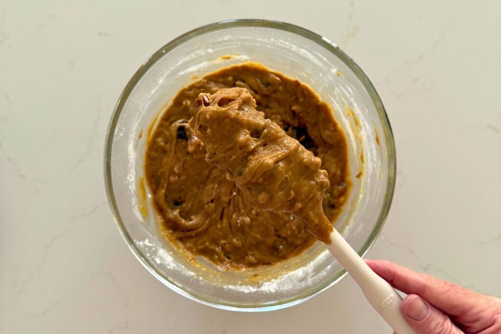 Close up to show the texture of the mixed cookie dough for sourdough date and walnut cookies.