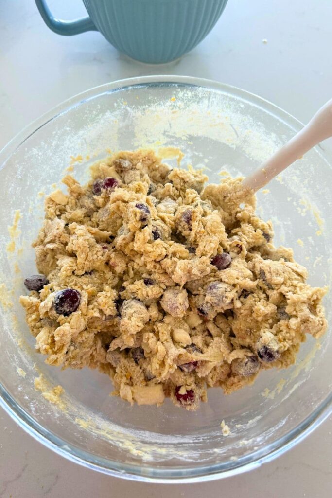 Mixing dough for sourdough orange and cranberry scones.