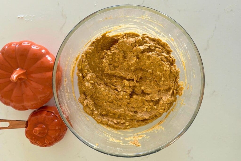 Sourdough pumpkin oatmeal cookie dough mixed in a bowl on the counter.