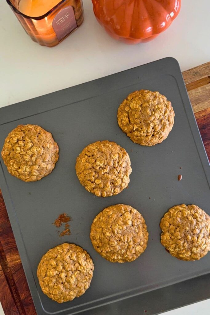 Fresh baked sourdough pumpkin oatmeal cookies on baking sheet to cool.
