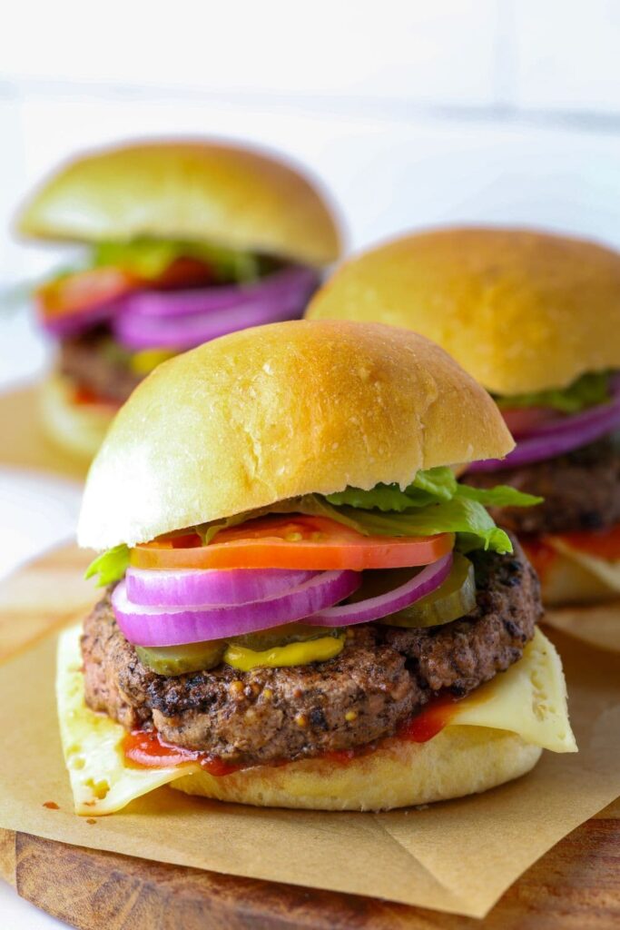 Assembled burger on cutting board with a sourdough burger bun.