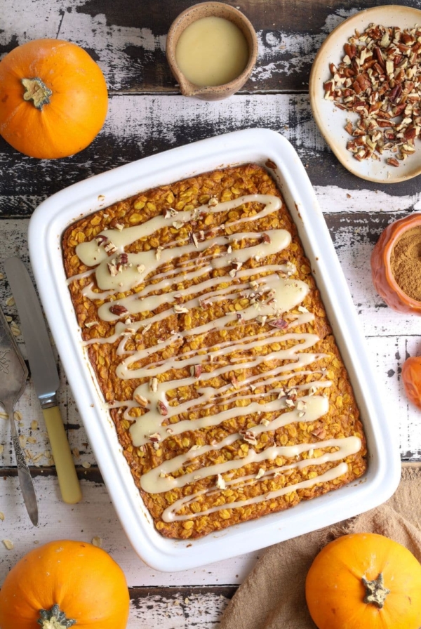 Fresh baked sourdough pumpkin pie baked oatmeal in baking dish with glaze on top.