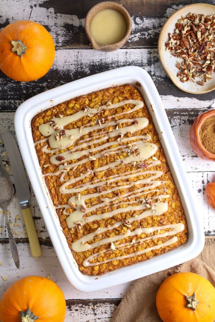 Fresh baked sourdough pumpkin pie baked oatmeal in baking dish with glaze on top.