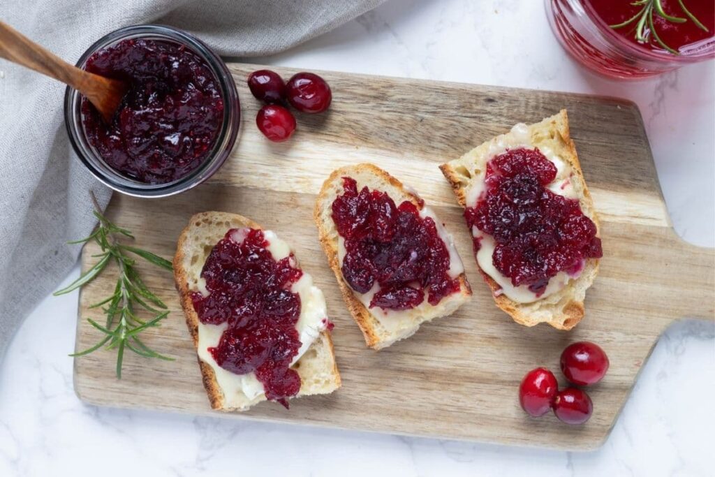 Three slices of sourdough bread topped with cranberry vanilla jam.