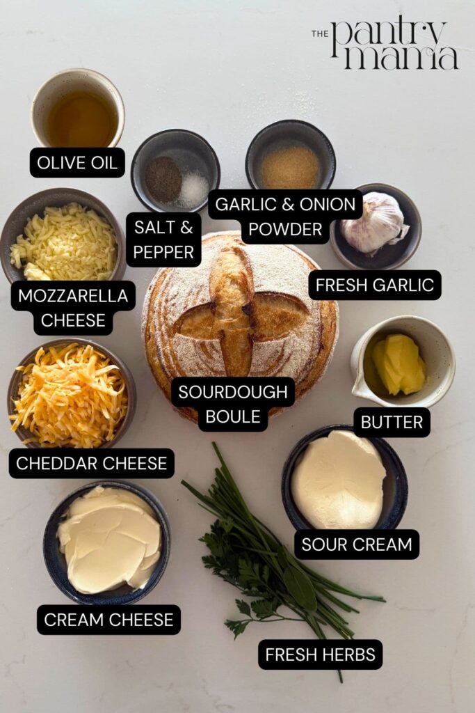 Labeled ingredients on the counter to make a sourdough cheese and garlic cobb loaf dip.