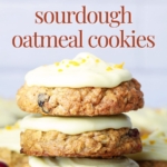 Three orange cranberry sourdough oatmeal cookies stacked with text overlay for Pinterest Pin image.