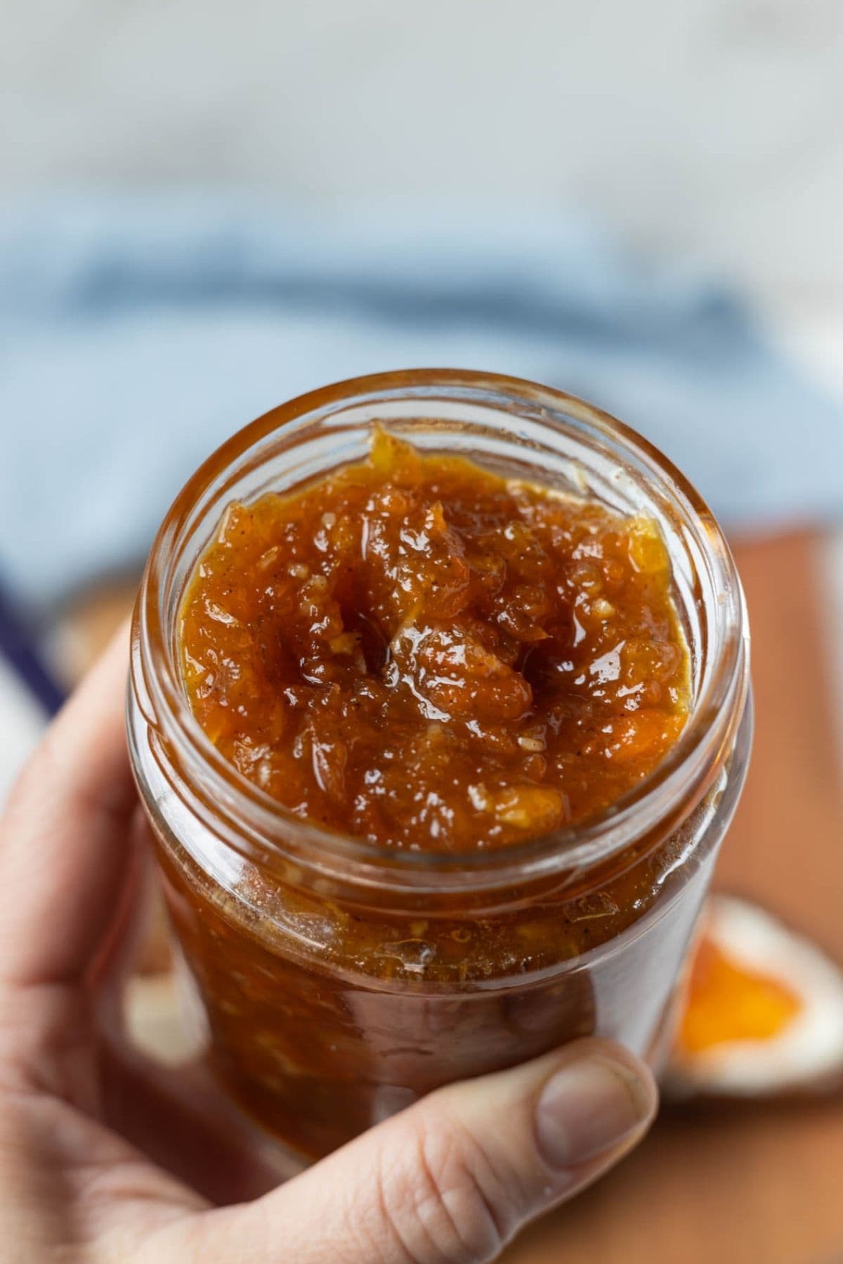 Close up of the inside of an open jar of carrot cake jam to show texture.