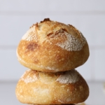 Two sourdough mini boules fresh baked and stacked.