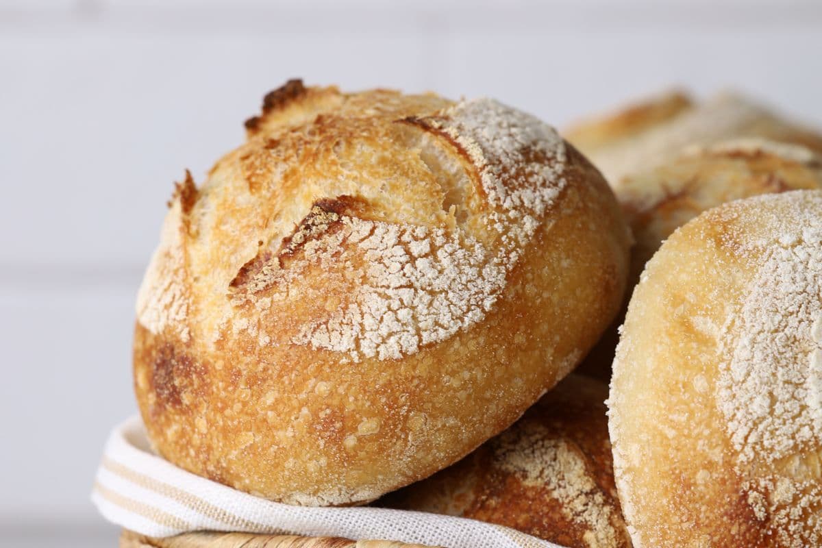 Close up of a mini sourdough boule in a basket for serving.