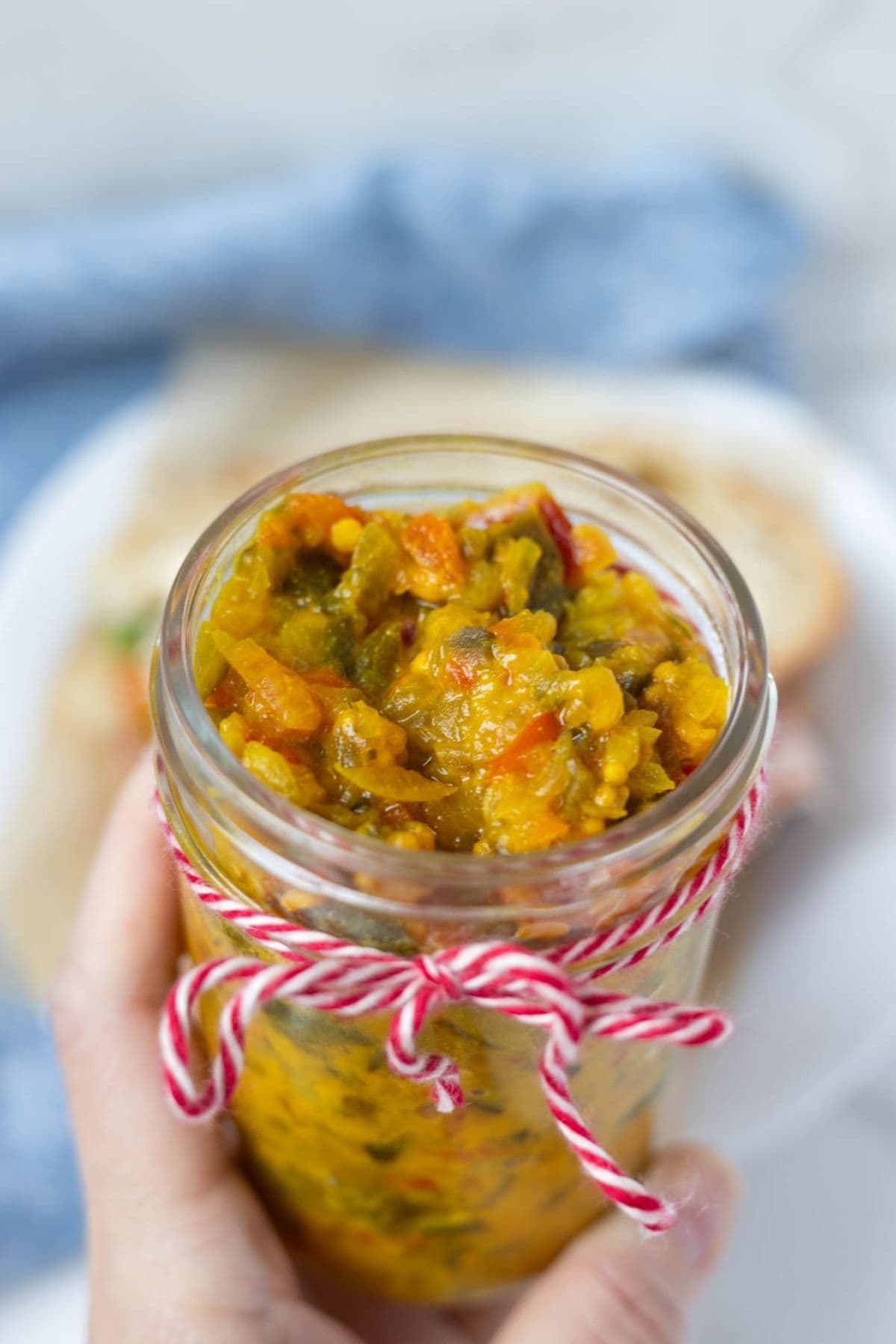 Mustard relish in a jar with lid off to show texture.