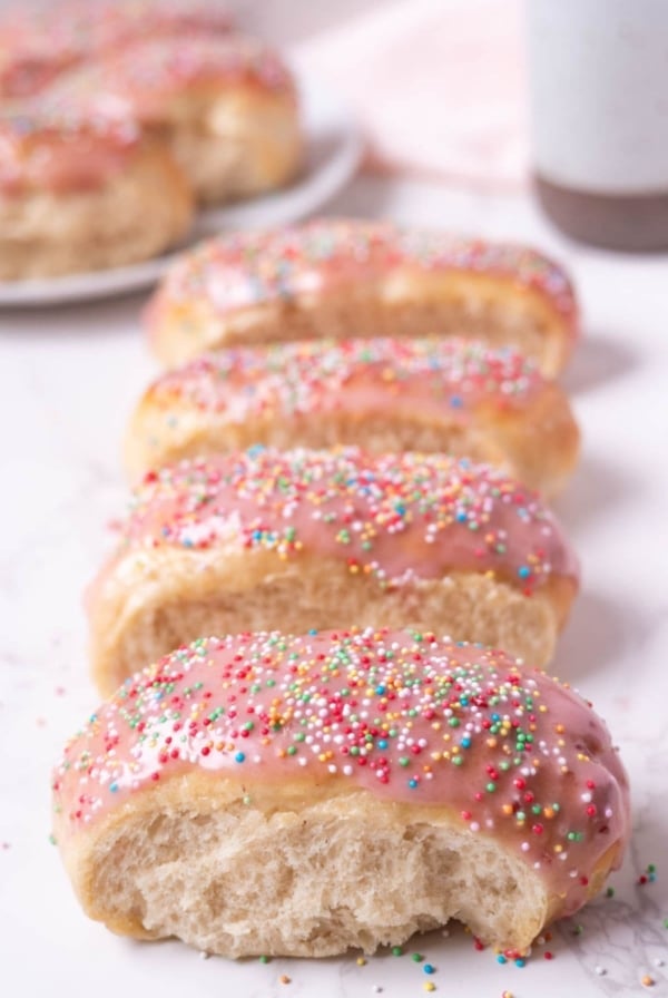 Four Sourdough discard iced buns lined up on the counter.