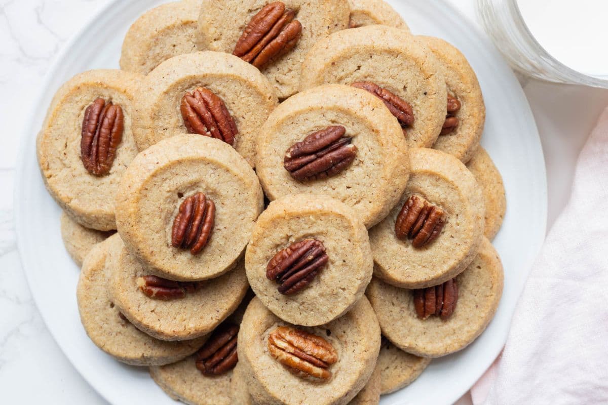 A batch of sourdough discard pecan sandies on a plate for serving.