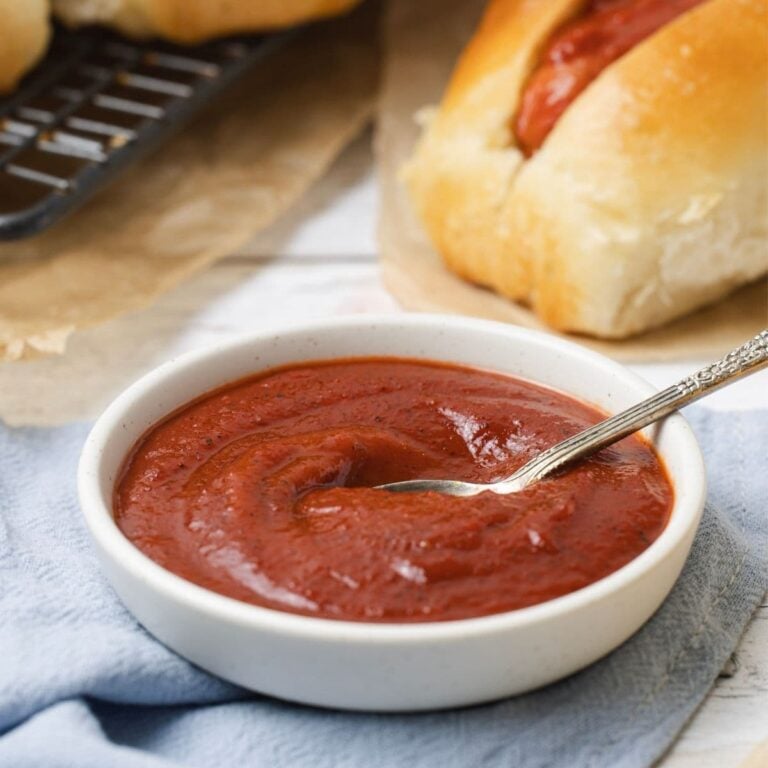 Close up of homemade ketchup with a spoon for serving.
