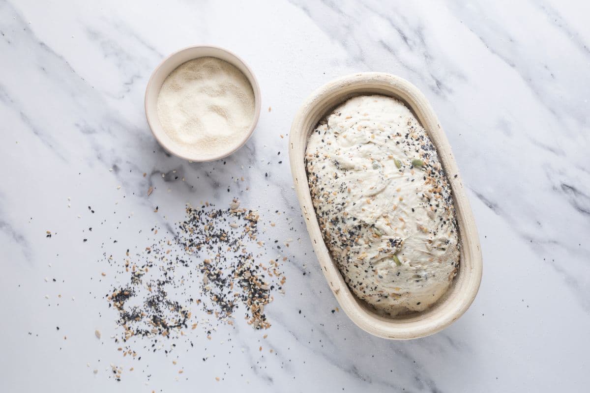 Multigrain sourdough bread dough in banneton ready for cold ferment.