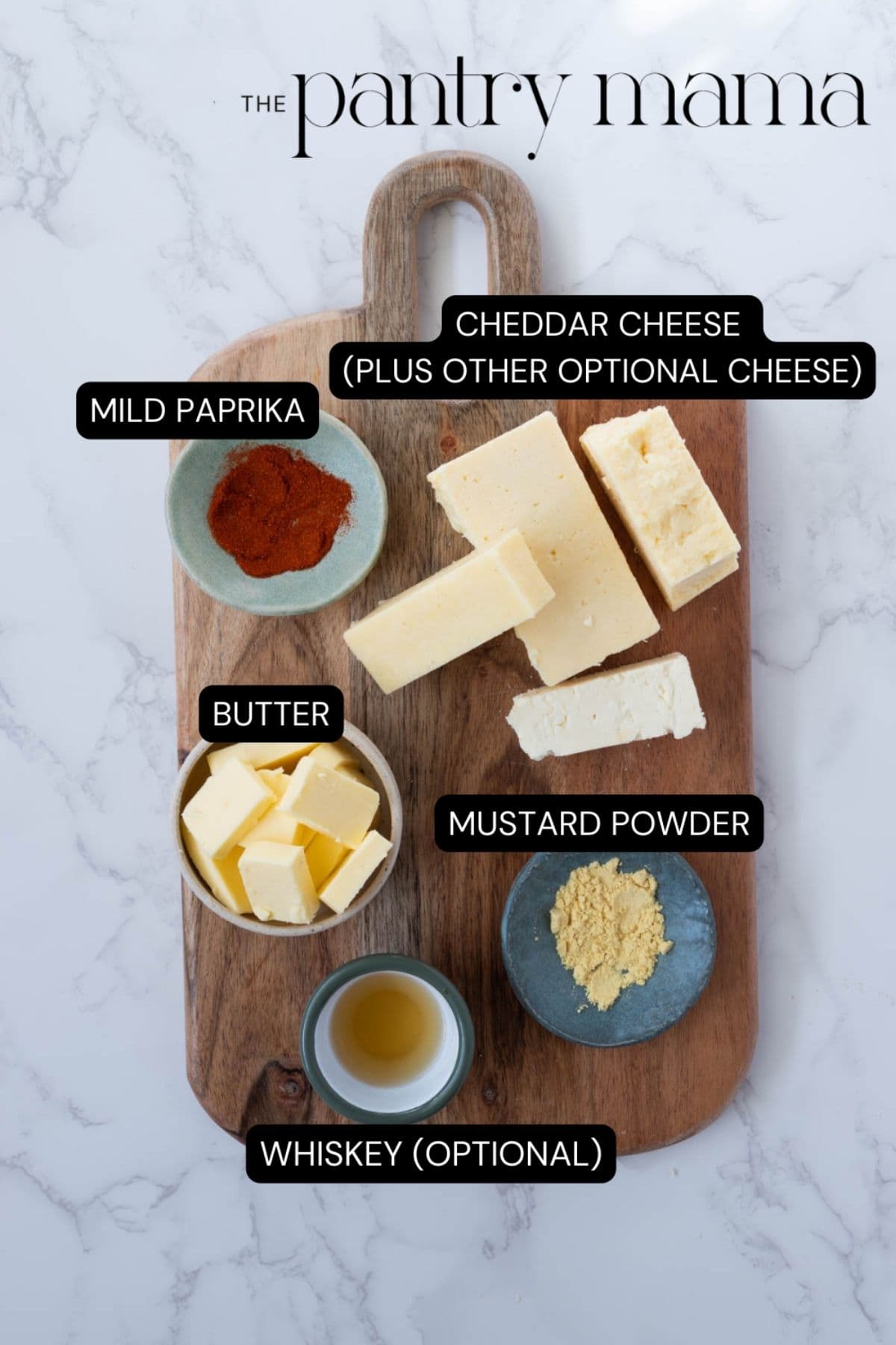 Labeled ingredients on a cutting board to make potted cheese.