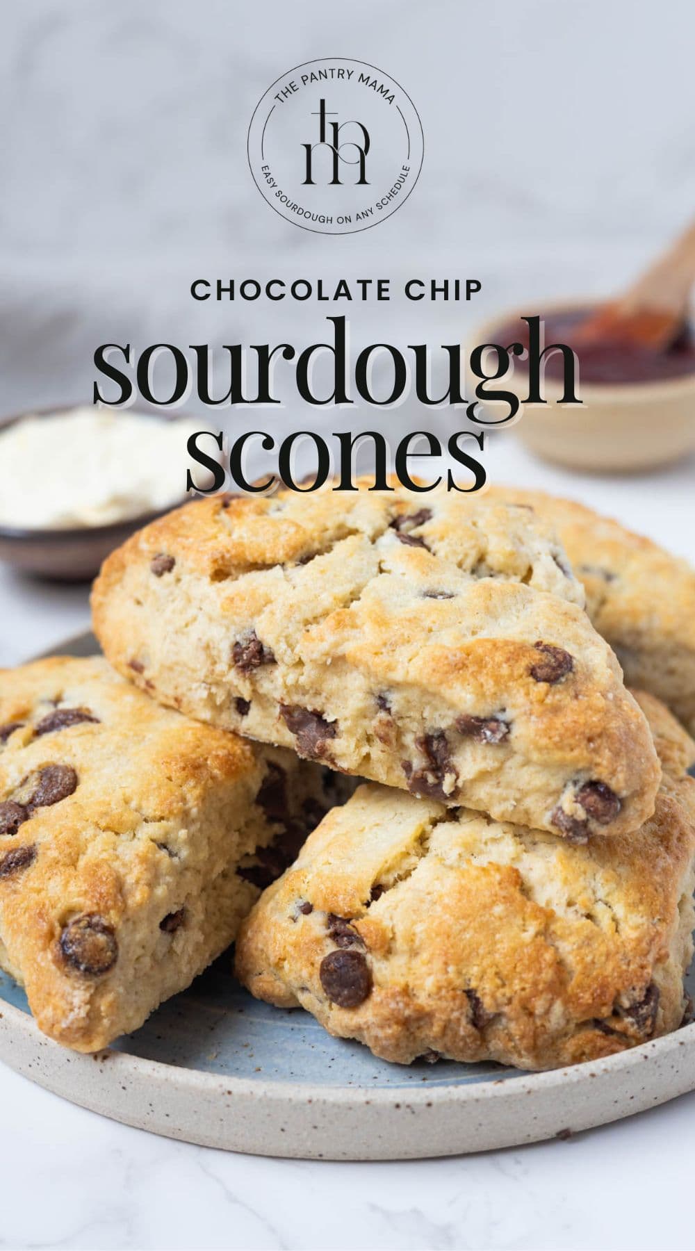 Stacked sourdough chocolate chip scones on a plate with text overlay reading chocolate chip sourdough scones for Pinterest Pin.