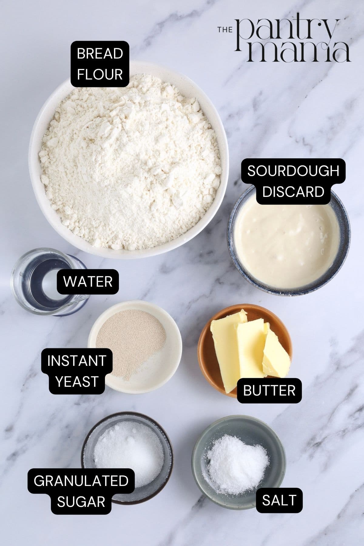 Flat lay image of ingredients necessary to make sourdough discard rolls.