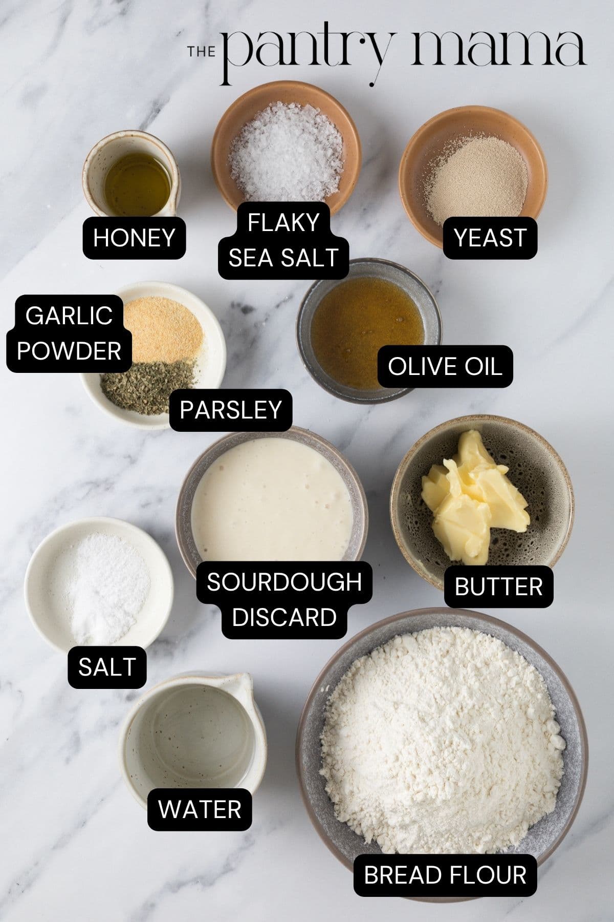 Labeled ingredients on counter to make sourdough garlic knots.