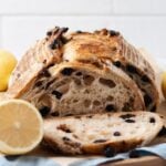 Close up of a loaf of sourdough lemon blueberry bread sliced open to see inside texture.