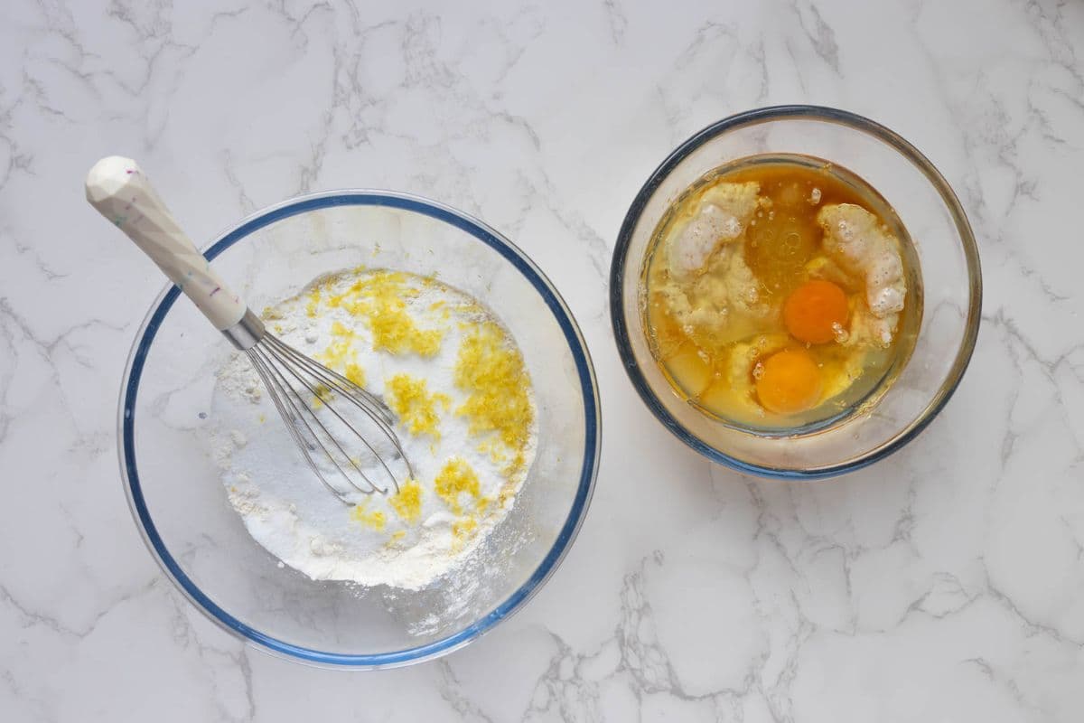 Mixing wet ingredients and dry ingredients in separate bowls to make sourdough lemon muffins.