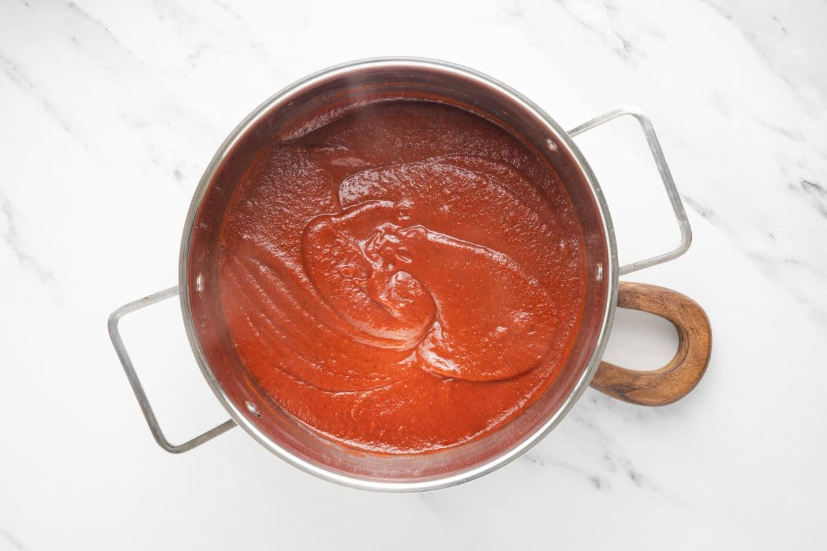 Homemade ketchup in a pot after blending with an immersion blender.