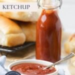 A bowl of homemade ketchup ready to be spooned on hotdogs with text overlay for a Pinterest Pin image.