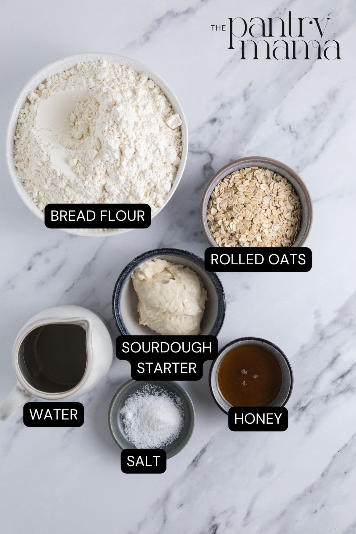 Labeled ingredients on the counter to make sourdough honey oat bread.