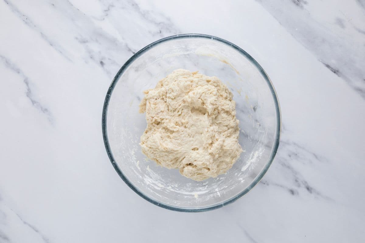 Shaggy dough in a bowl to make sourdough discard rolls.