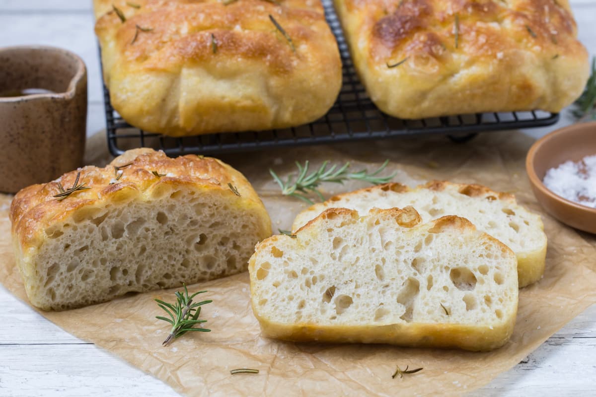 Close up of a sliced open loaf of simple sourdough focaccia bread to show inside texture.