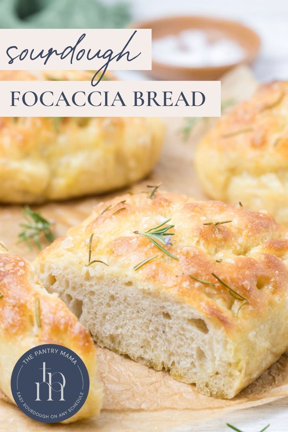A sliced open loaf of simple sourdough focaccia bread on parchment paper with text overlay for a Pinterest Pin image.