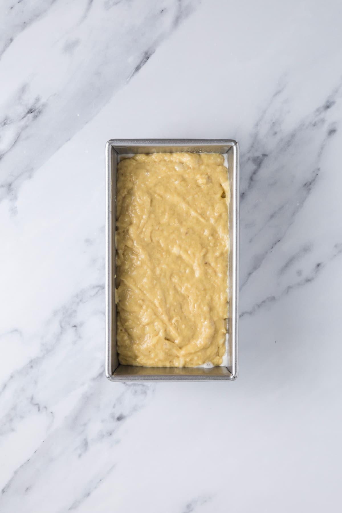 Batter in a loaf pan to make sourdough discard banana bread.