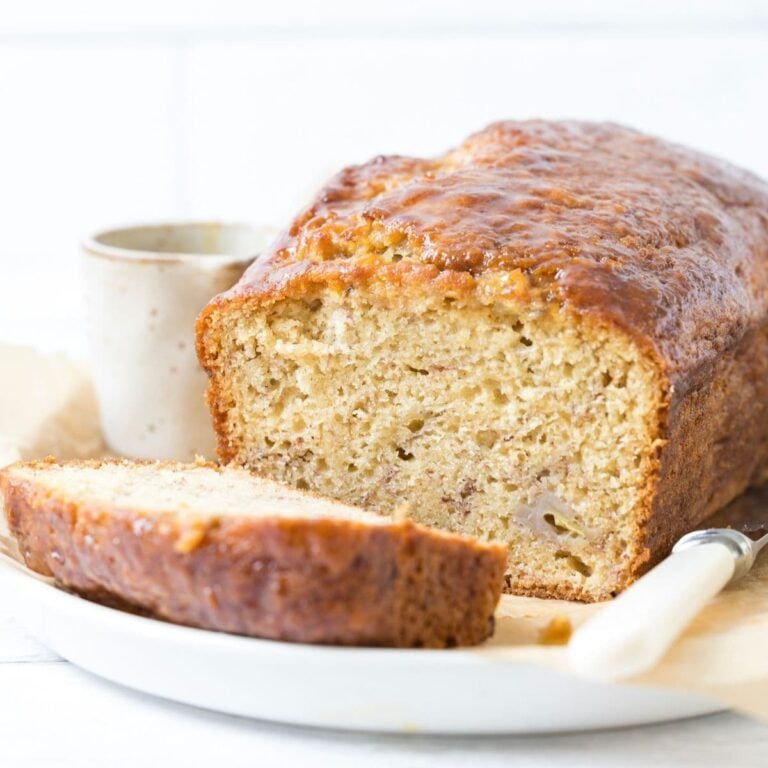 A loaf of sourdough discard banana bread sliced open to show inside texture.