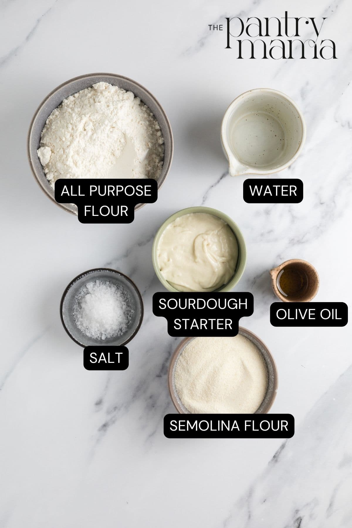 Labeled ingredients on the counter to make sourdough parchment crackers.