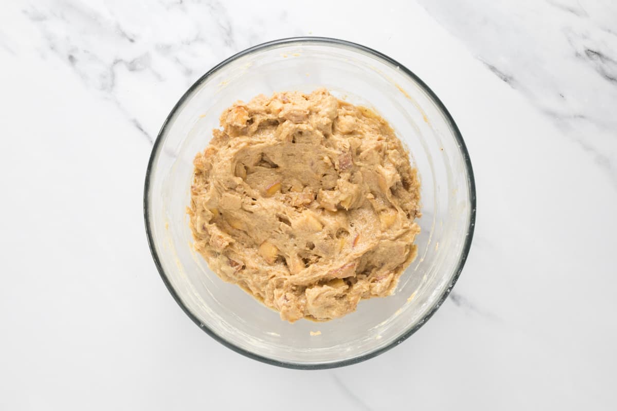 Sourdough peach cobbler muffin dough in a bowl ready to be added to muffin cups.