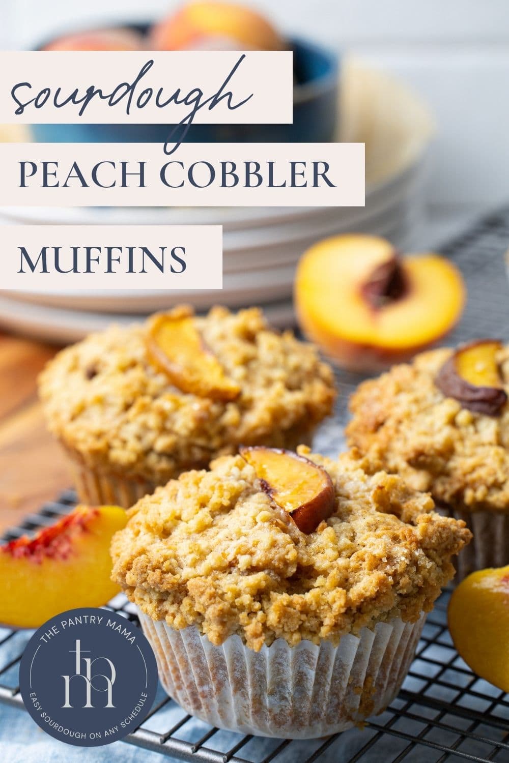 Close up image of sourdough peach cobbler muffins cooling on a wire rack with text overlay for a Pinterest Pin image.