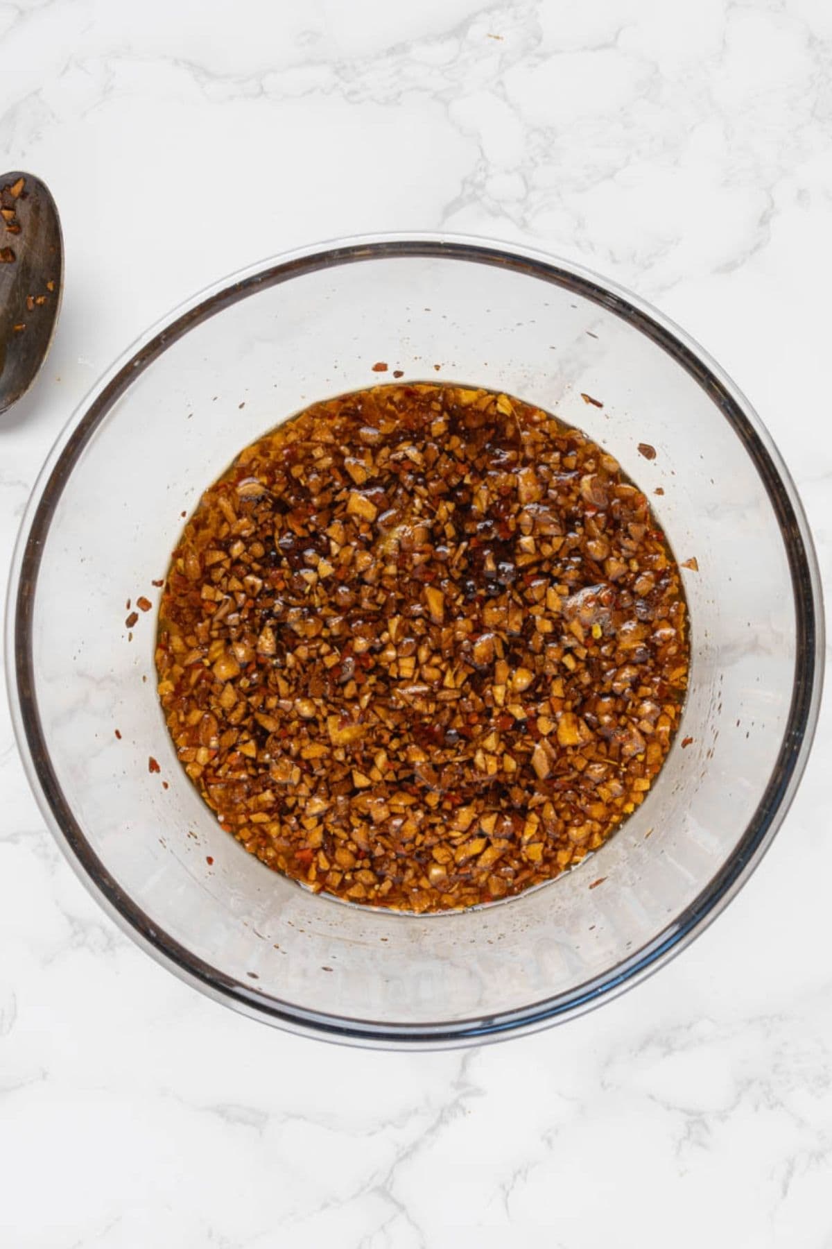 Hot chili crunch oil ingredients mixed together in a glass bowl.