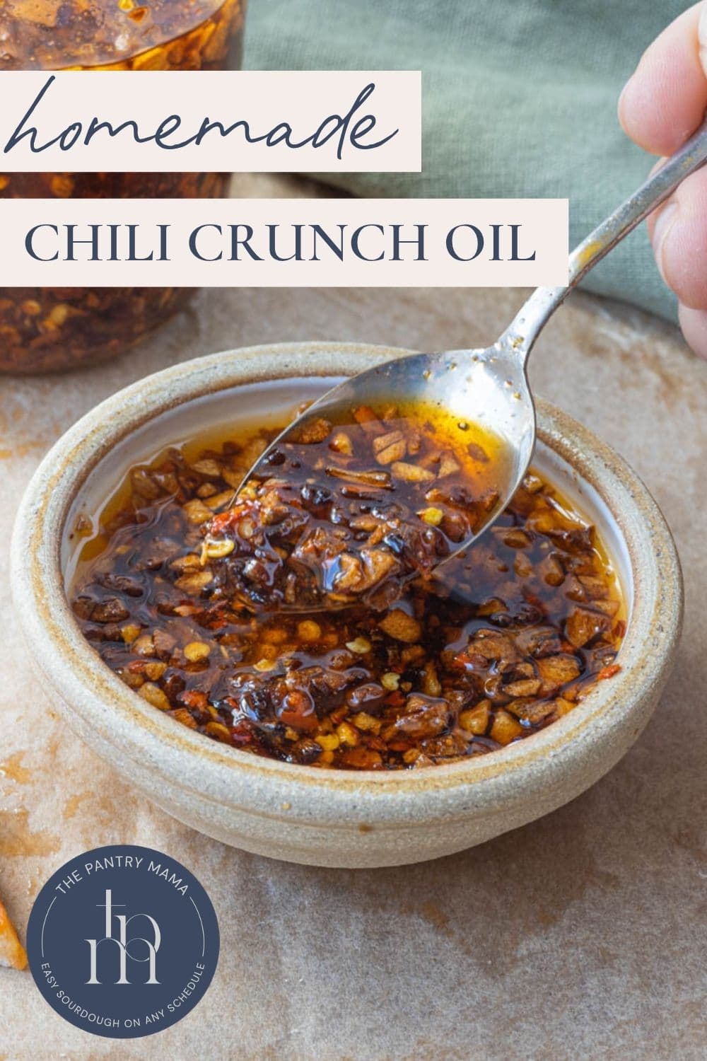 Pinterest image with text overlay for homemade chili crunch oil featuring crispy garlic chili oil in a bowl.