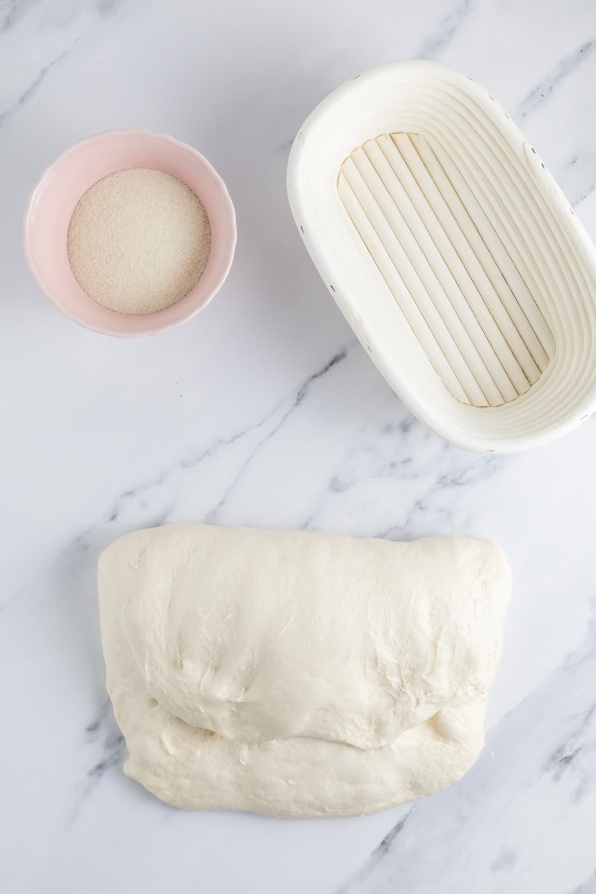 Folding same day sourdough bread dough over itself for shaping.