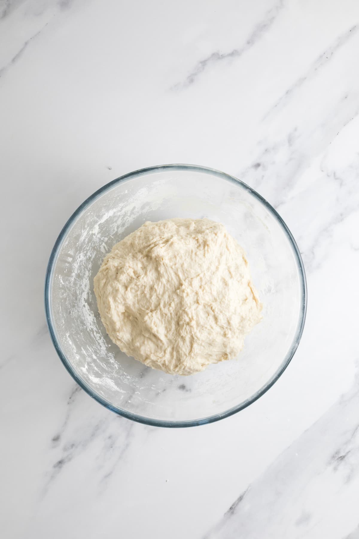 Same day sourdough dough after mixing, resting in a glass bowl before stretching and folding.