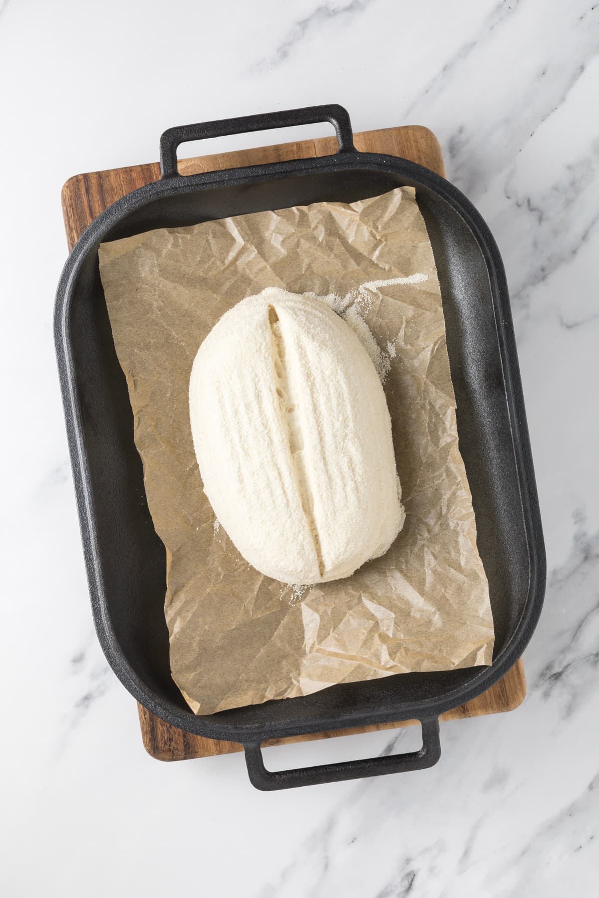 Top view of proofed small batch sourdough bread dough in bread pan ready to bake.