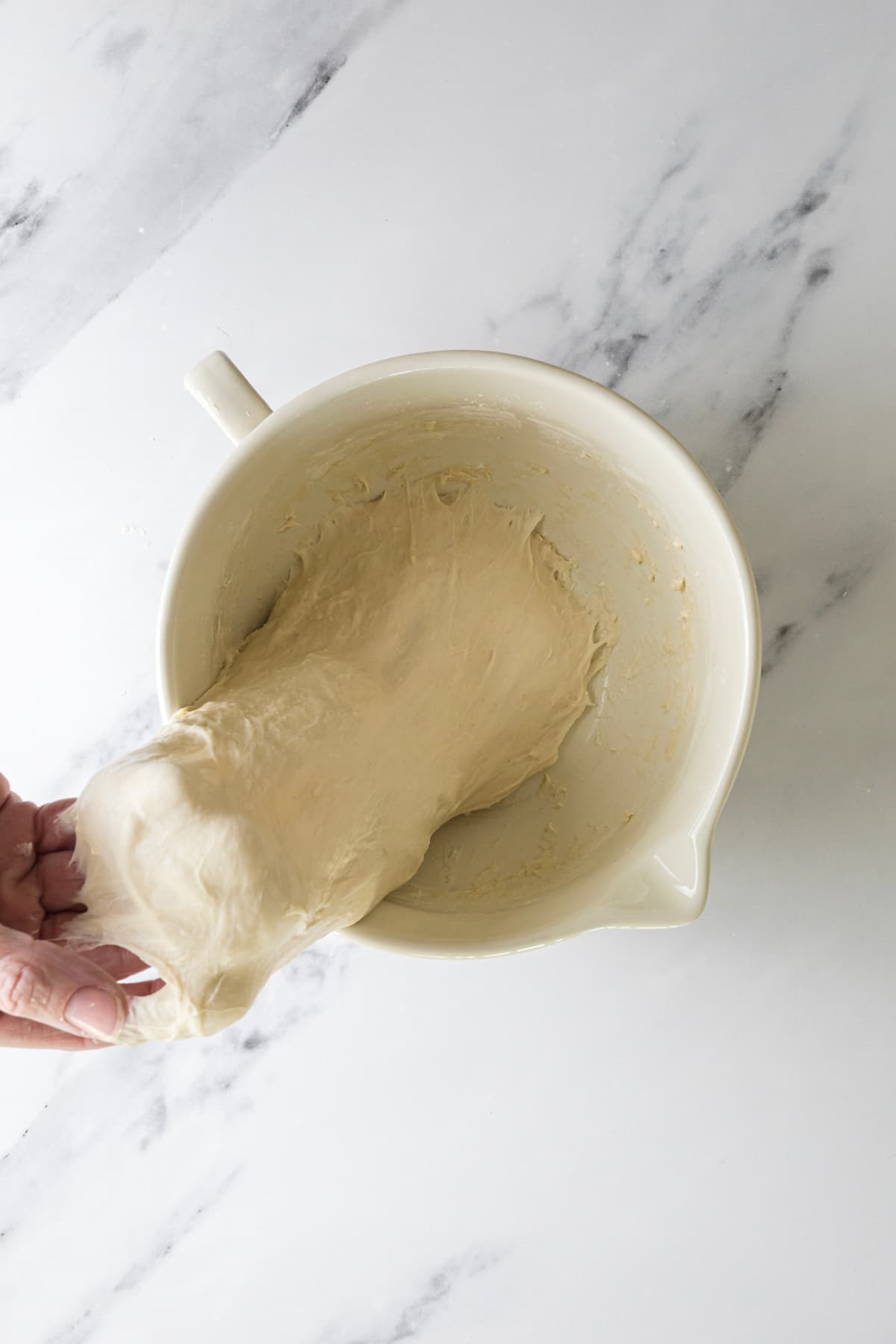 Stretching small batch sourdough bread dough during the stretch and fold process.